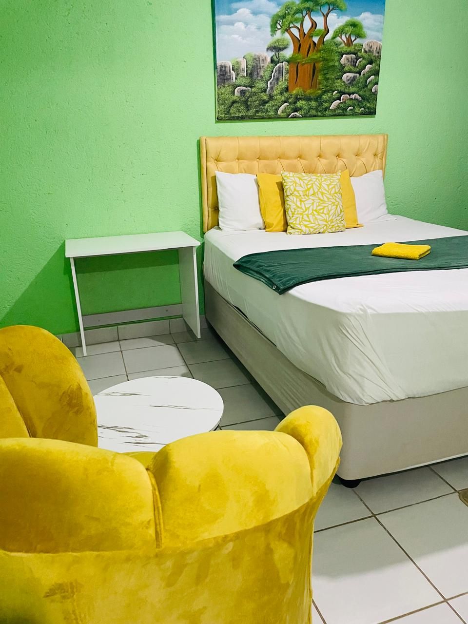 Yellow velvet armchairs and a baobab painting inside The Room