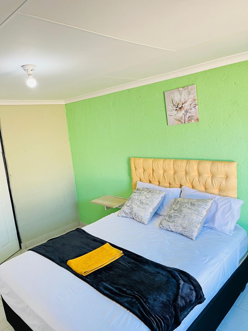Cream headboard and floral artwork